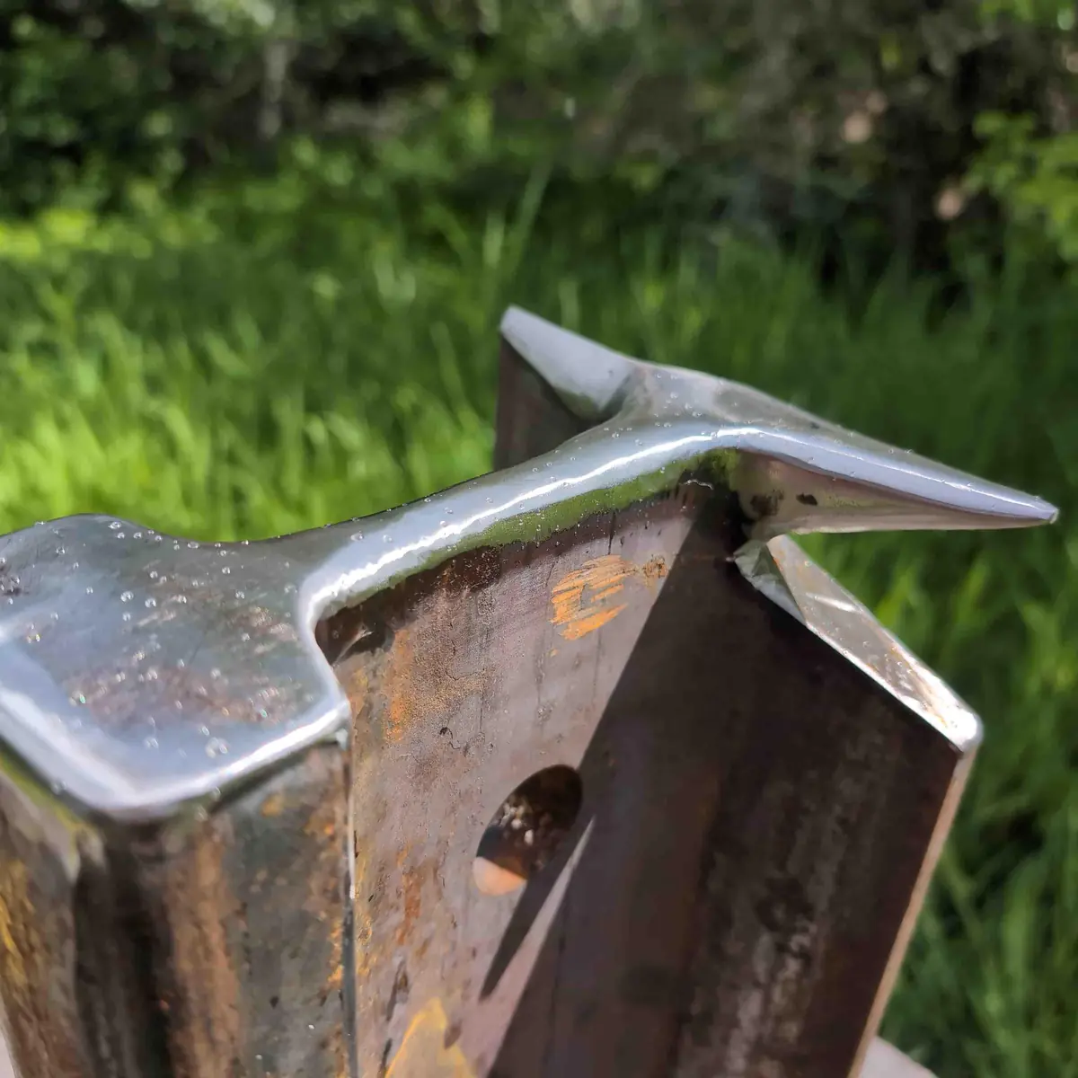 Close up showing the shaped bick and hot cut on a vertical rail anvil.