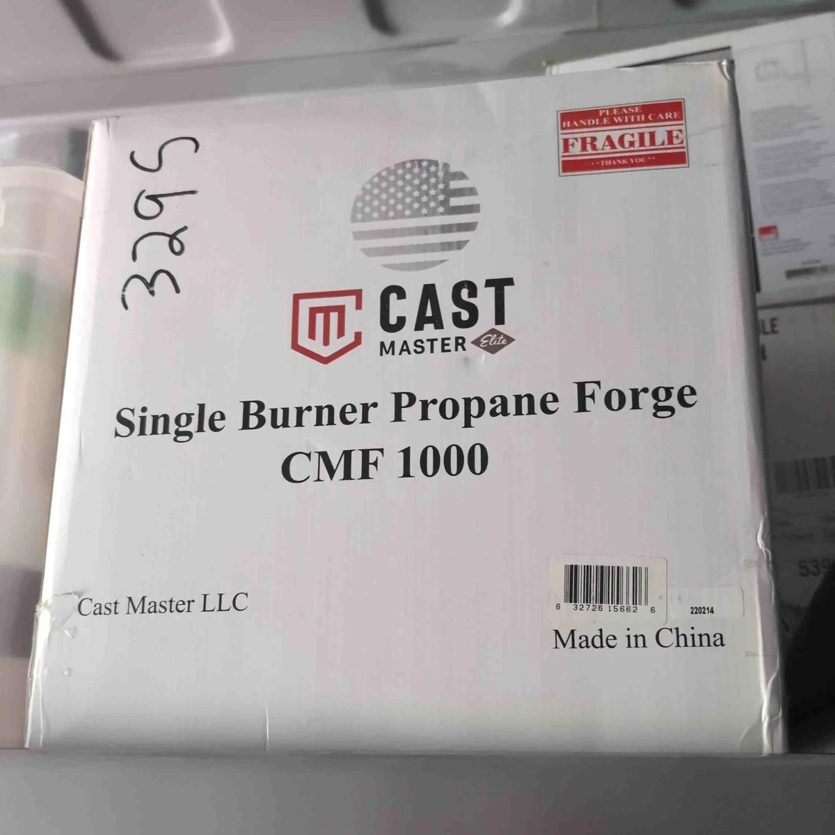 A white box labeled Cast Master Single Burner Propane Forge CMF1000